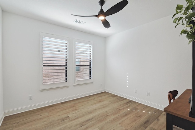 empty room featuring light wood-type flooring and ceiling fan