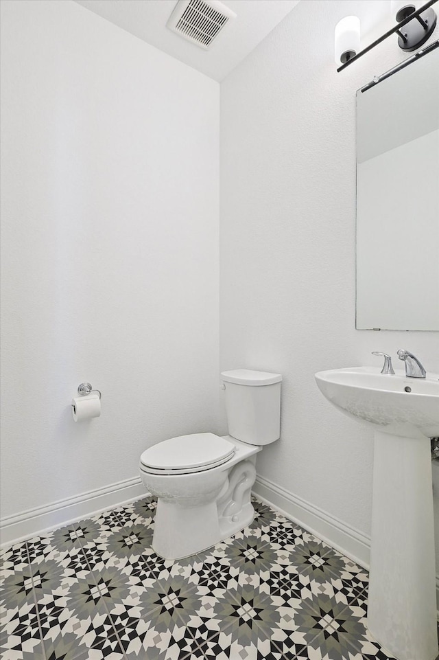 bathroom with sink, tile patterned floors, and toilet