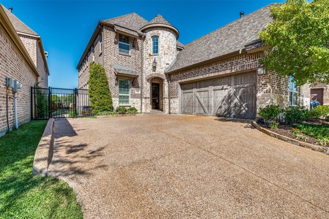 french country style house with a garage