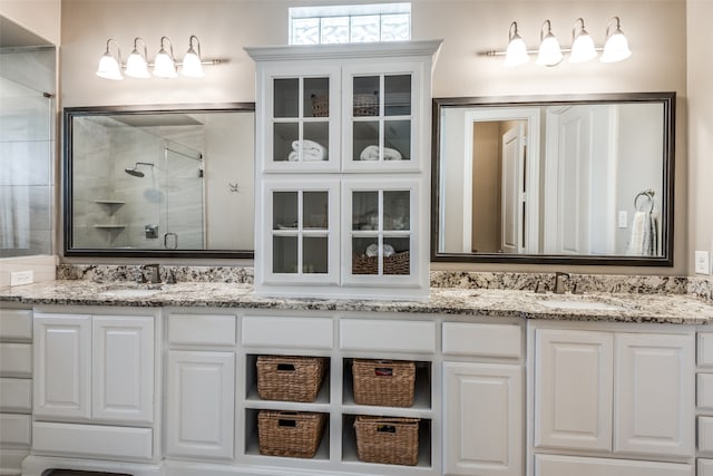 bathroom featuring vanity and an enclosed shower