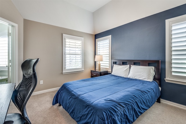 bedroom featuring carpet flooring and vaulted ceiling