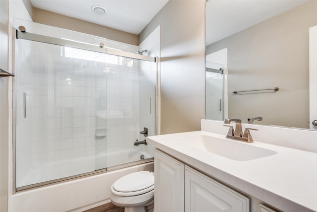 full bathroom with shower / bath combination with glass door, vanity, and toilet