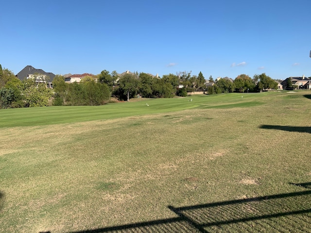 view of home's community with a yard