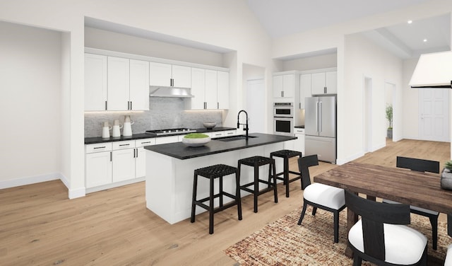 kitchen featuring a kitchen island with sink, sink, white cabinets, and stainless steel appliances