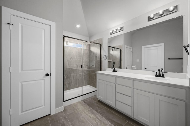 bathroom featuring vaulted ceiling, tile patterned flooring, an enclosed shower, and vanity