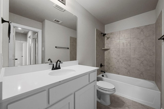 full bathroom featuring toilet, tile patterned flooring, tiled shower / bath combo, and vanity