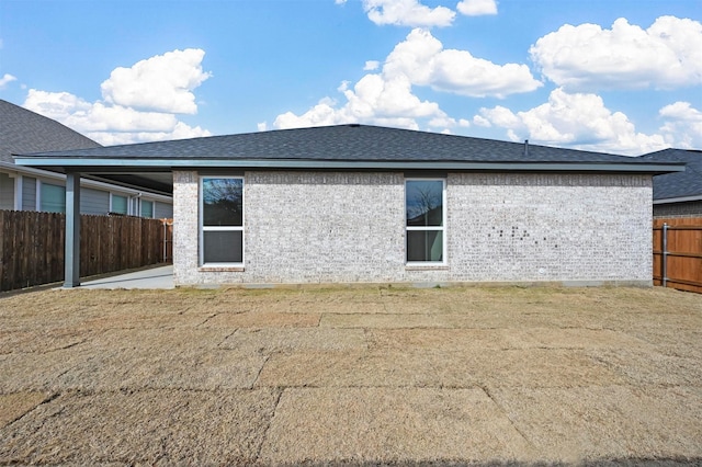 back of house with a patio area and a yard