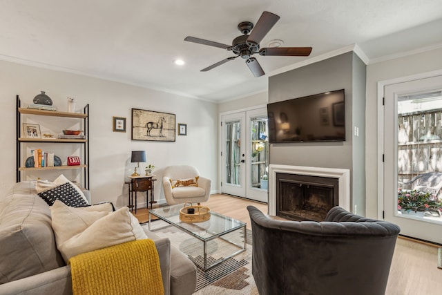 living room with ceiling fan, light wood-type flooring, and a wealth of natural light