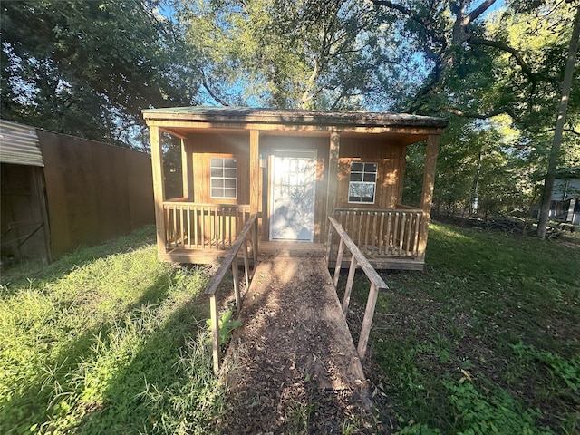 rear view of property featuring a porch