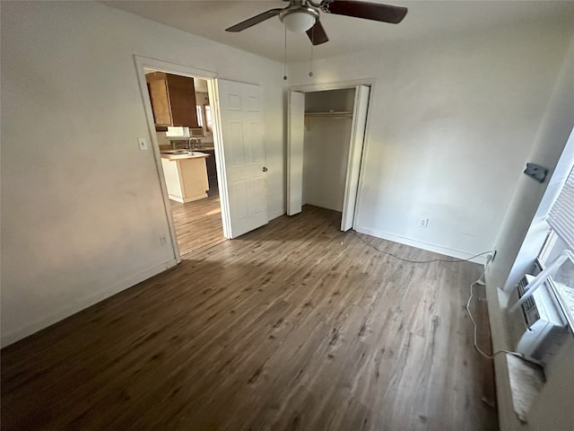 unfurnished bedroom featuring sink, ceiling fan, a closet, and light hardwood / wood-style flooring