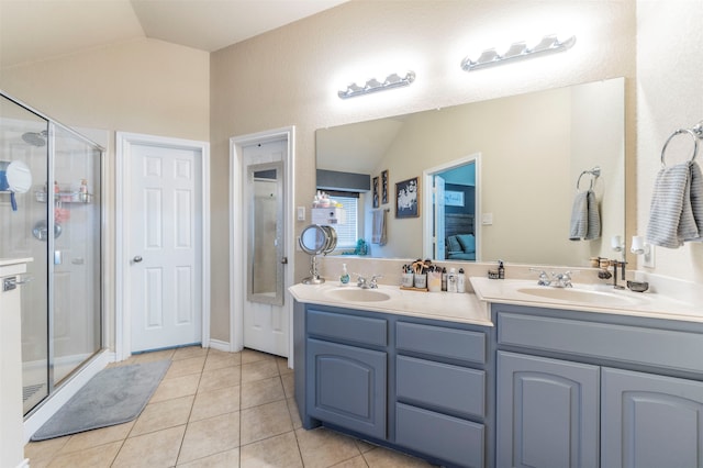 bathroom featuring lofted ceiling, vanity, tile patterned floors, and a shower with door