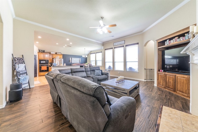 living room featuring ceiling fan, crown molding, and dark wood-type flooring