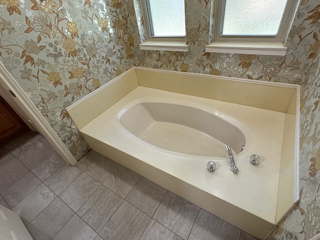 bathroom featuring a tub and a skylight