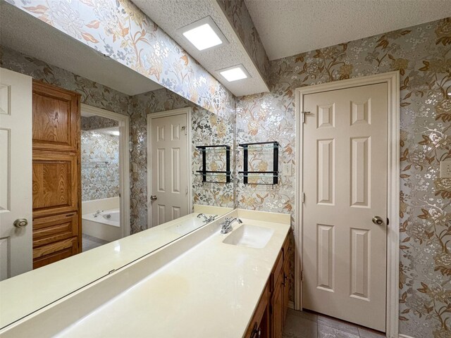 bathroom featuring vanity and a tub