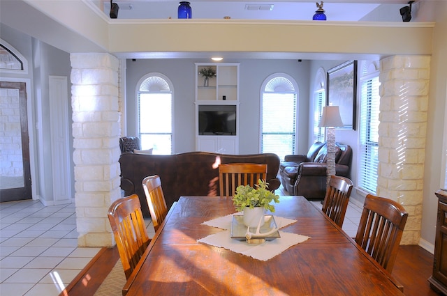 tiled dining space with built in features and a healthy amount of sunlight