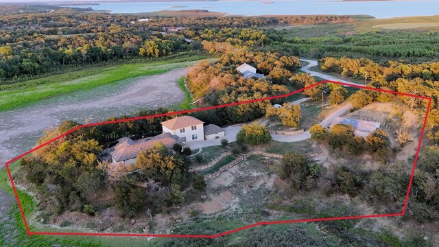 birds eye view of property with a view of trees