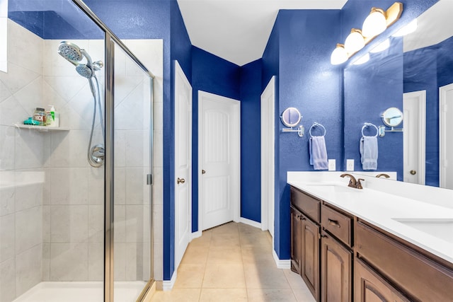 bathroom with tile patterned flooring, vanity, and a shower with shower door