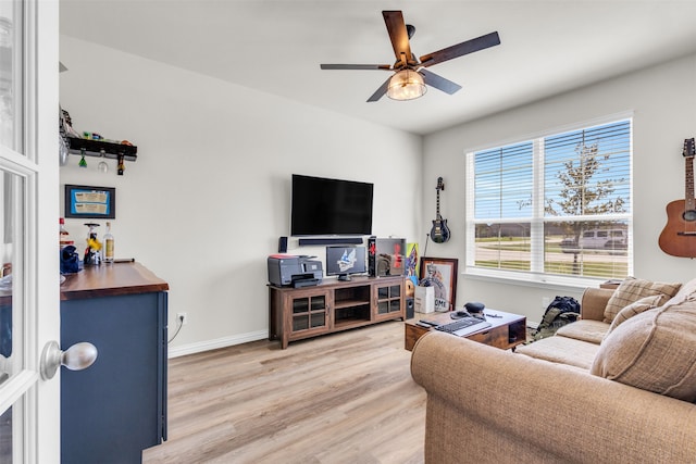 living room with ceiling fan and hardwood / wood-style flooring