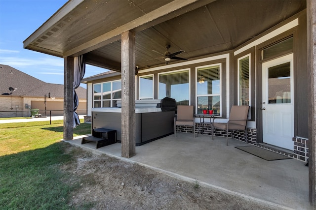 view of patio with a hot tub and ceiling fan