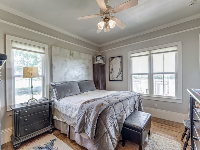 bedroom featuring ceiling fan, hardwood / wood-style floors, and crown molding