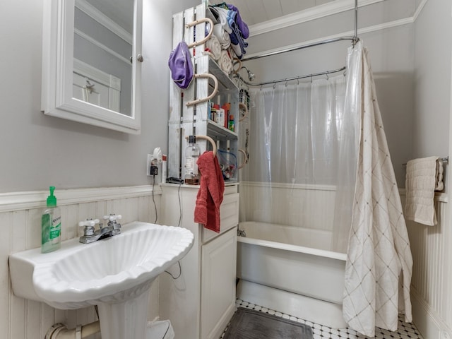 bathroom with ornamental molding, sink, and shower / bath combo with shower curtain