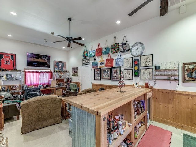 kitchen featuring ceiling fan and wood counters