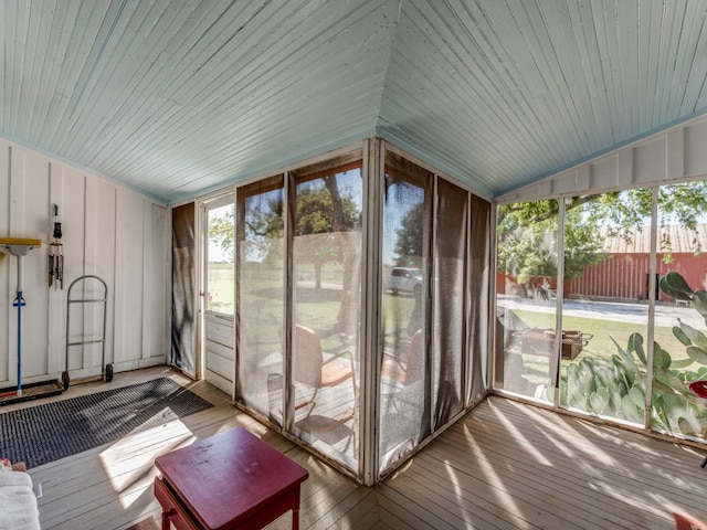 unfurnished sunroom with wood ceiling and vaulted ceiling