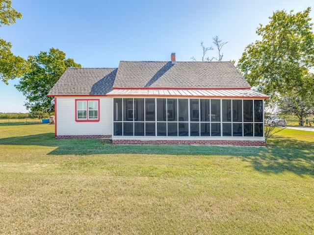 back of house featuring a sunroom and a yard