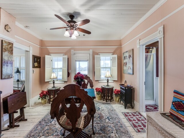 sitting room featuring light hardwood / wood-style flooring, ceiling fan, and crown molding