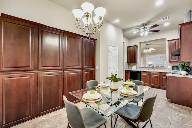 dining room featuring ceiling fan with notable chandelier and sink