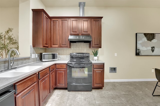 kitchen featuring light tile patterned floors, appliances with stainless steel finishes, backsplash, and sink