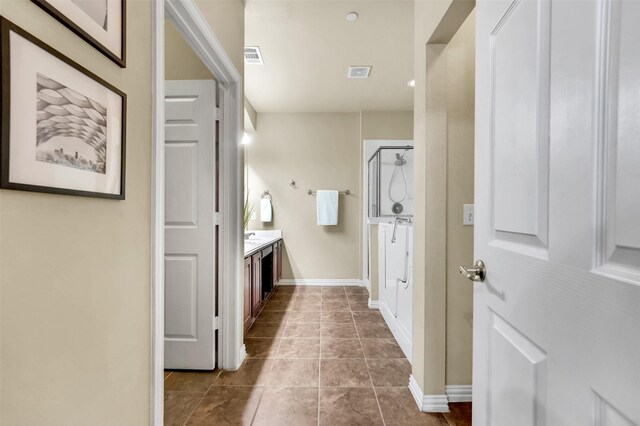 bedroom with ceiling fan, vaulted ceiling, and tile patterned floors