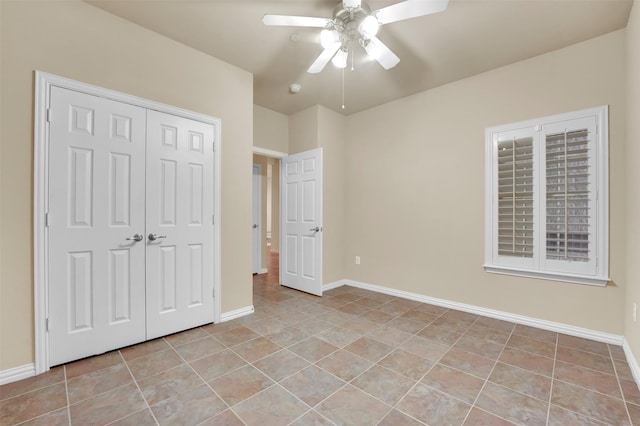 unfurnished bedroom featuring light tile patterned floors, a closet, and ceiling fan