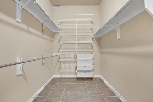 spacious closet featuring tile patterned flooring