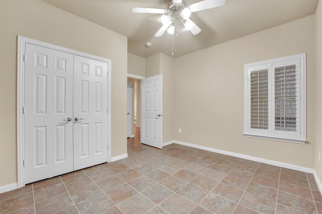 unfurnished bedroom with a closet, ceiling fan, and light tile patterned floors