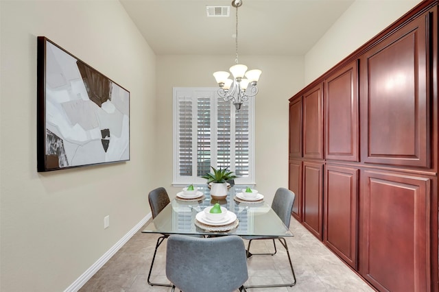 tiled dining room featuring an inviting chandelier