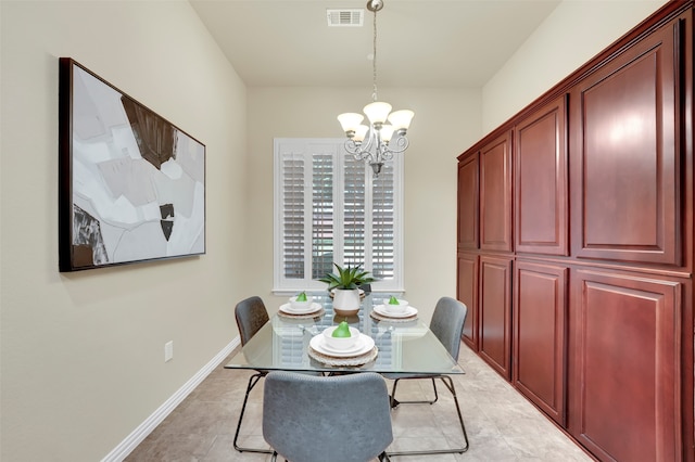 dining area featuring a notable chandelier and light tile patterned floors