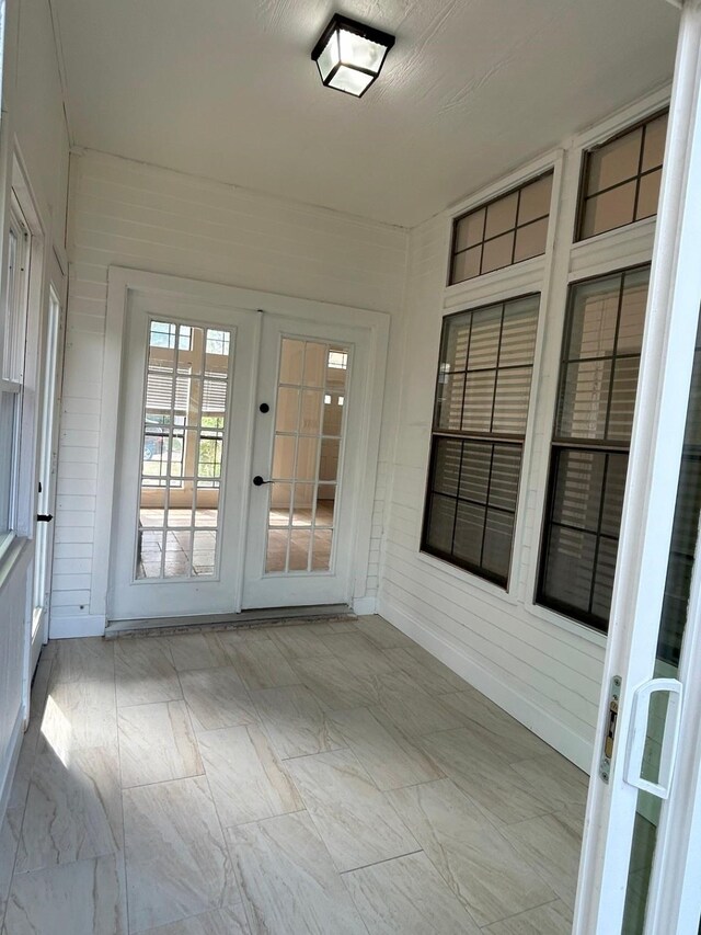 unfurnished sunroom featuring french doors