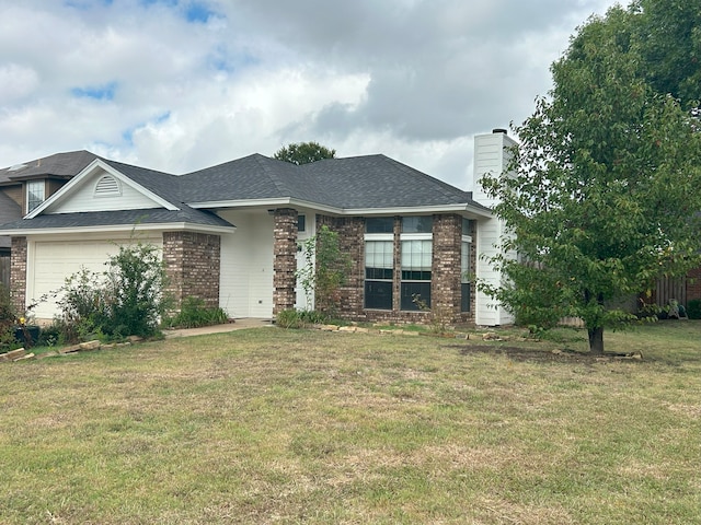 view of front facade featuring a garage and a front lawn