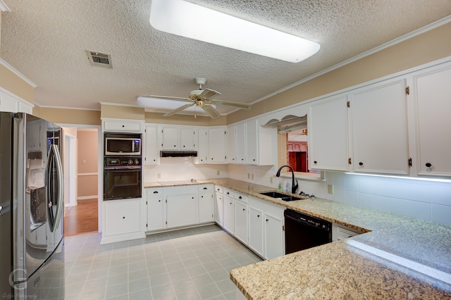 kitchen featuring crown molding, black appliances, white cabinetry, and sink