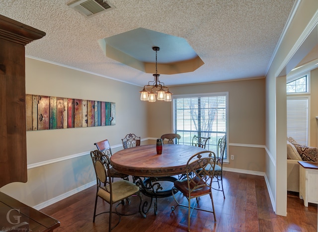 dining area featuring ornamental molding, a textured ceiling, plenty of natural light, and dark wood-type flooring