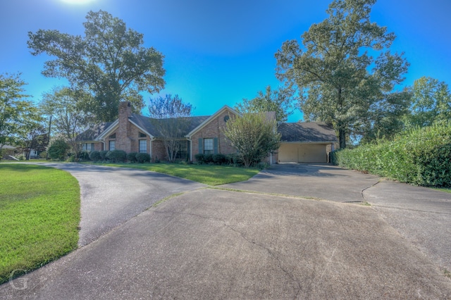 ranch-style home with a garage and a front yard