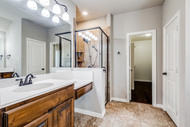 bathroom with vanity and a shower with door