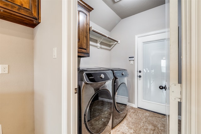 laundry room with washer and clothes dryer and cabinets