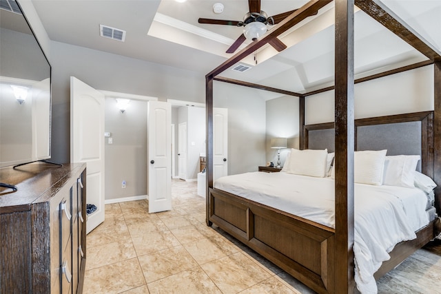 bedroom with ceiling fan, light tile patterned floors, and a raised ceiling