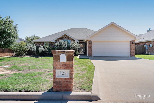 view of front of house featuring a garage and a front lawn