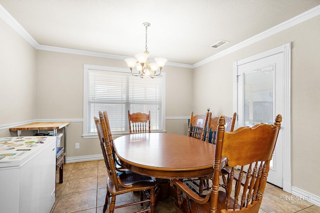 tiled dining area featuring washer / clothes dryer, an inviting chandelier, and crown molding