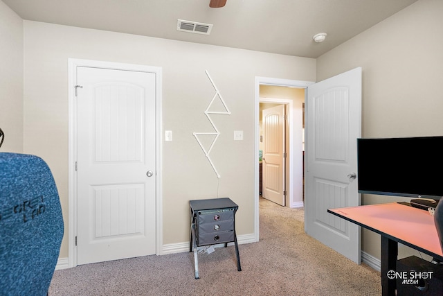 carpeted office with ceiling fan