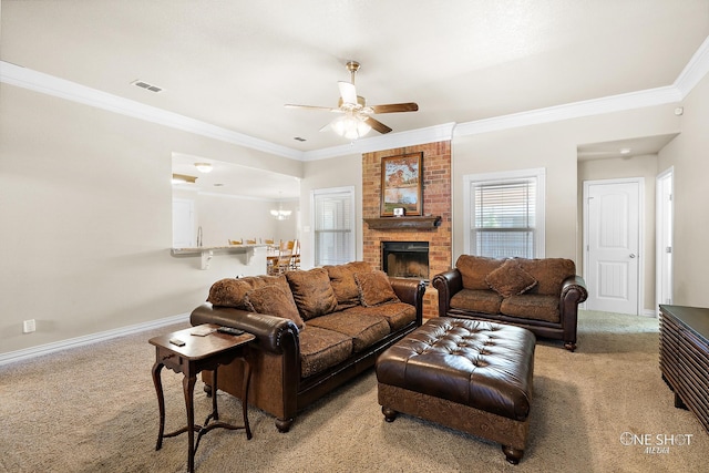 living room featuring ornamental molding, ceiling fan, light colored carpet, and a fireplace