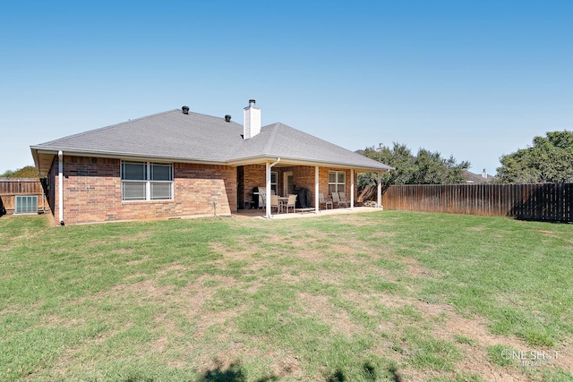 back of property featuring a lawn and a patio area